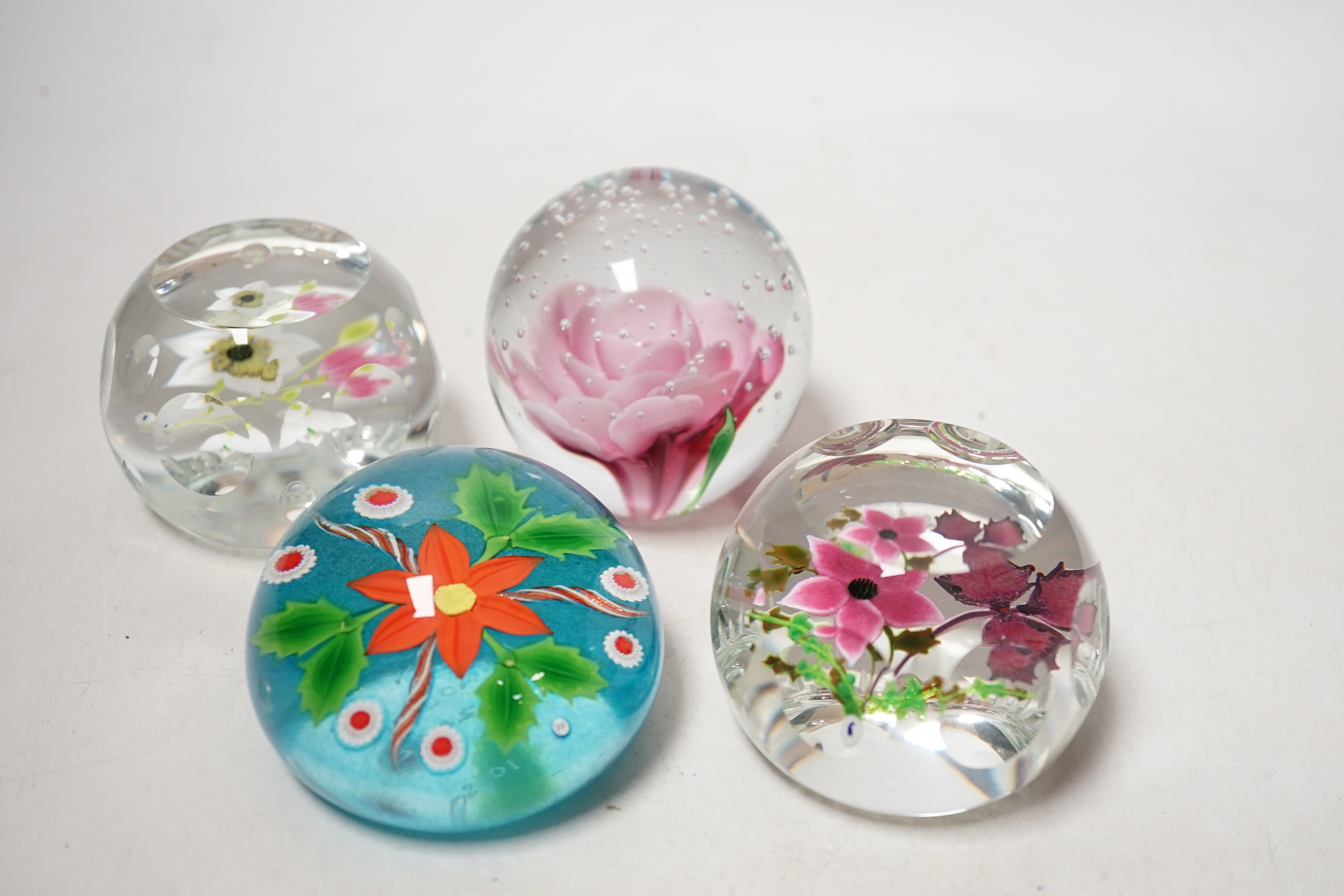 Four lampwork glass flower paperweights, Phoenix, 10/50, Caithness 199/250 and 194/250 and another, 7.5cm in diameter (4)